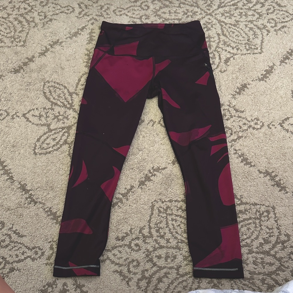 Lululemon Burgundy/Purple leggings with side zipper. About calf length.